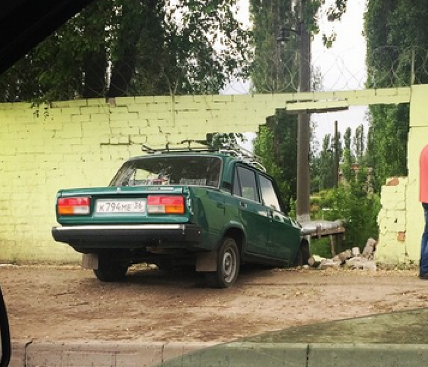 «Семерка» столкнулась с иномаркой и снесла кирпичный забор в Воронеже 